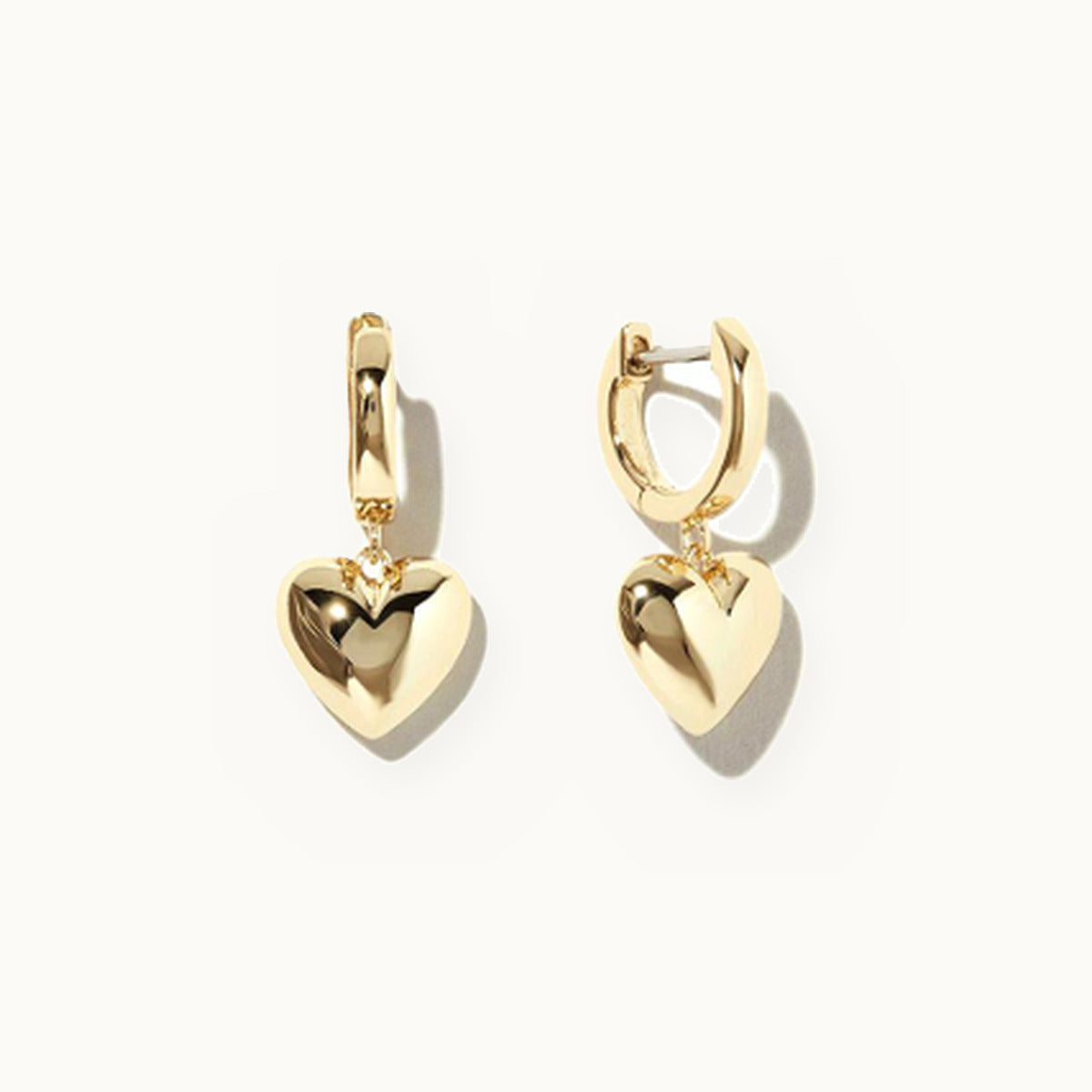 Gold huggie earrings with puffed heart drops