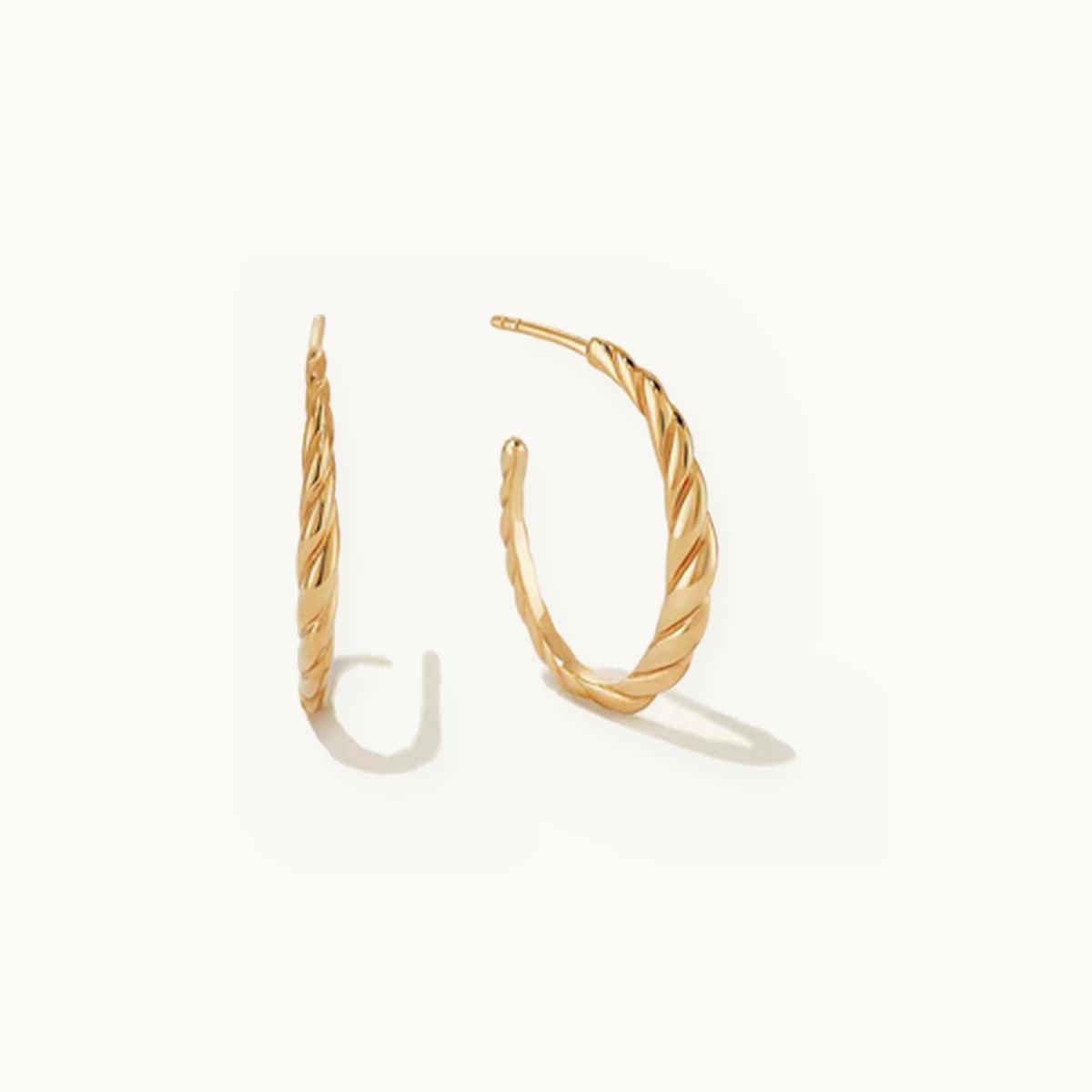 Pair of open gold hoop earrings with a twisted rope texture