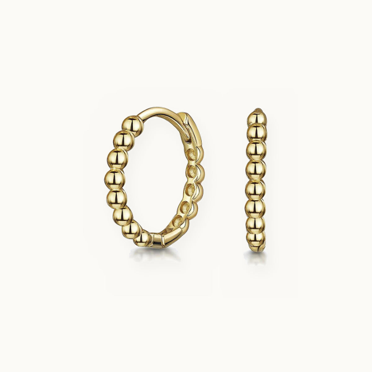 Pair of gold huggie earrings with rounded ball beads
