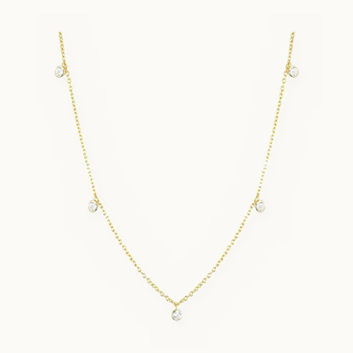 Gold chain necklace with hanging bezel-set stone drops