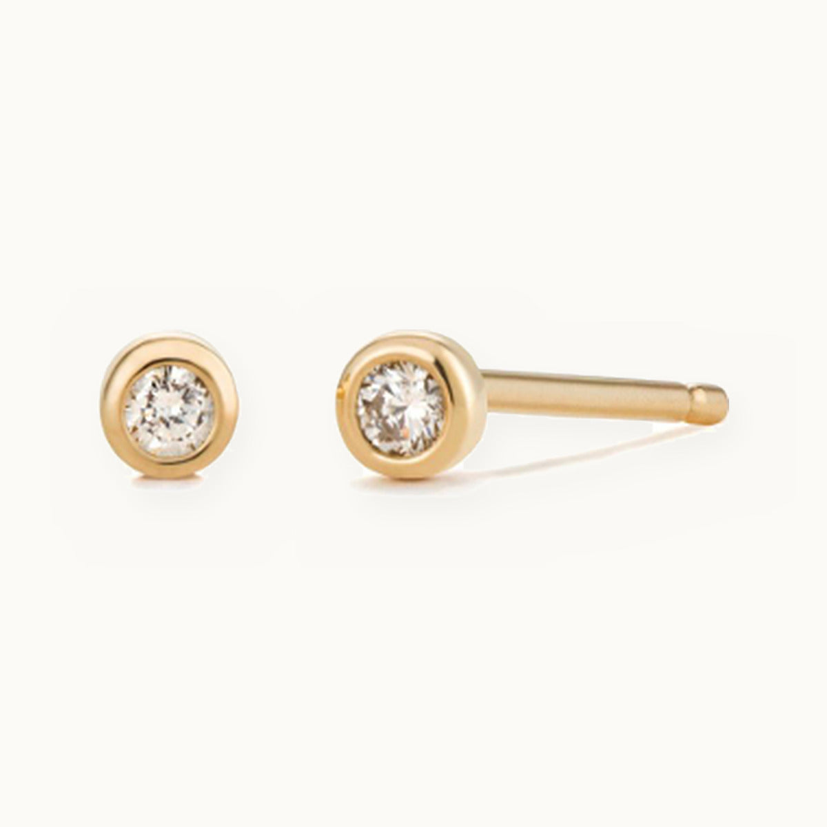 Pair of small gold bezel-set solitaire stud earrings