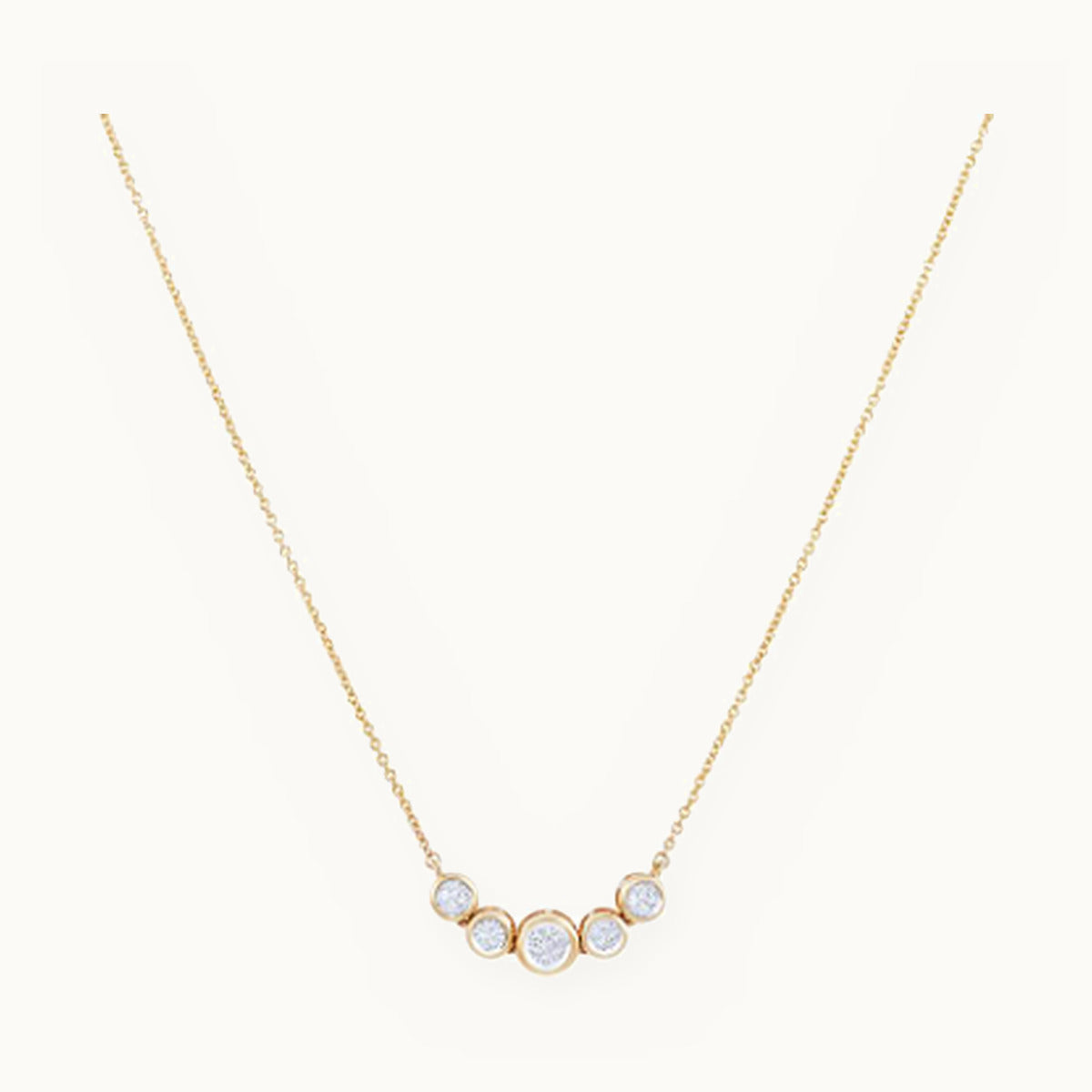 Gold necklace with a curved row of graduated bezel stones