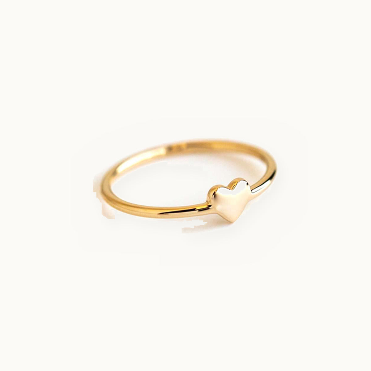 Fine gold ring with a small polished heart