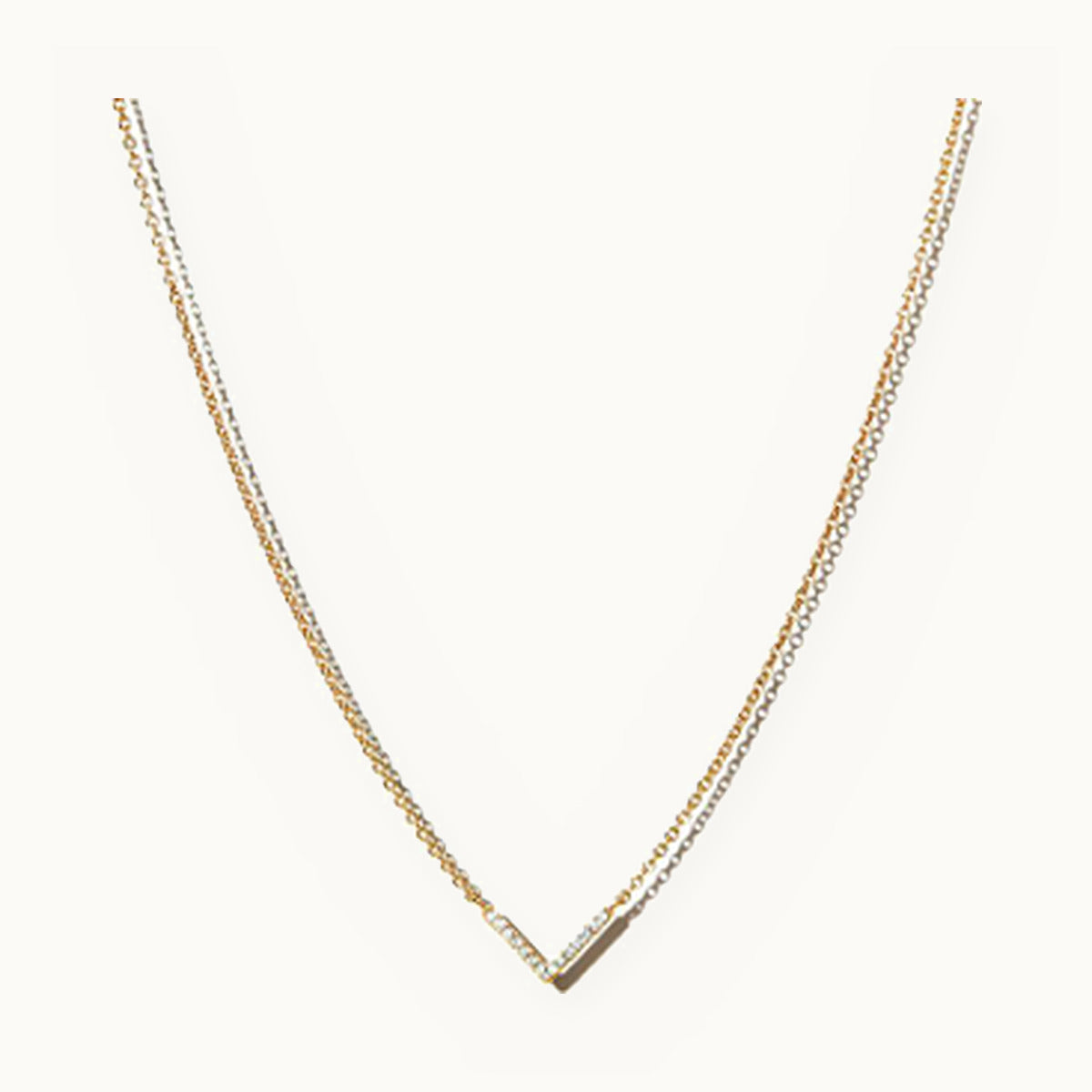 Layered gold necklace with a pavé chevron centre