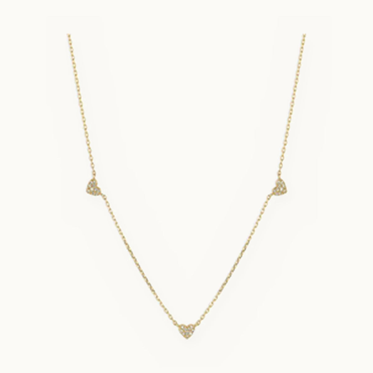 Gold chain necklace with three small pavé heart stations