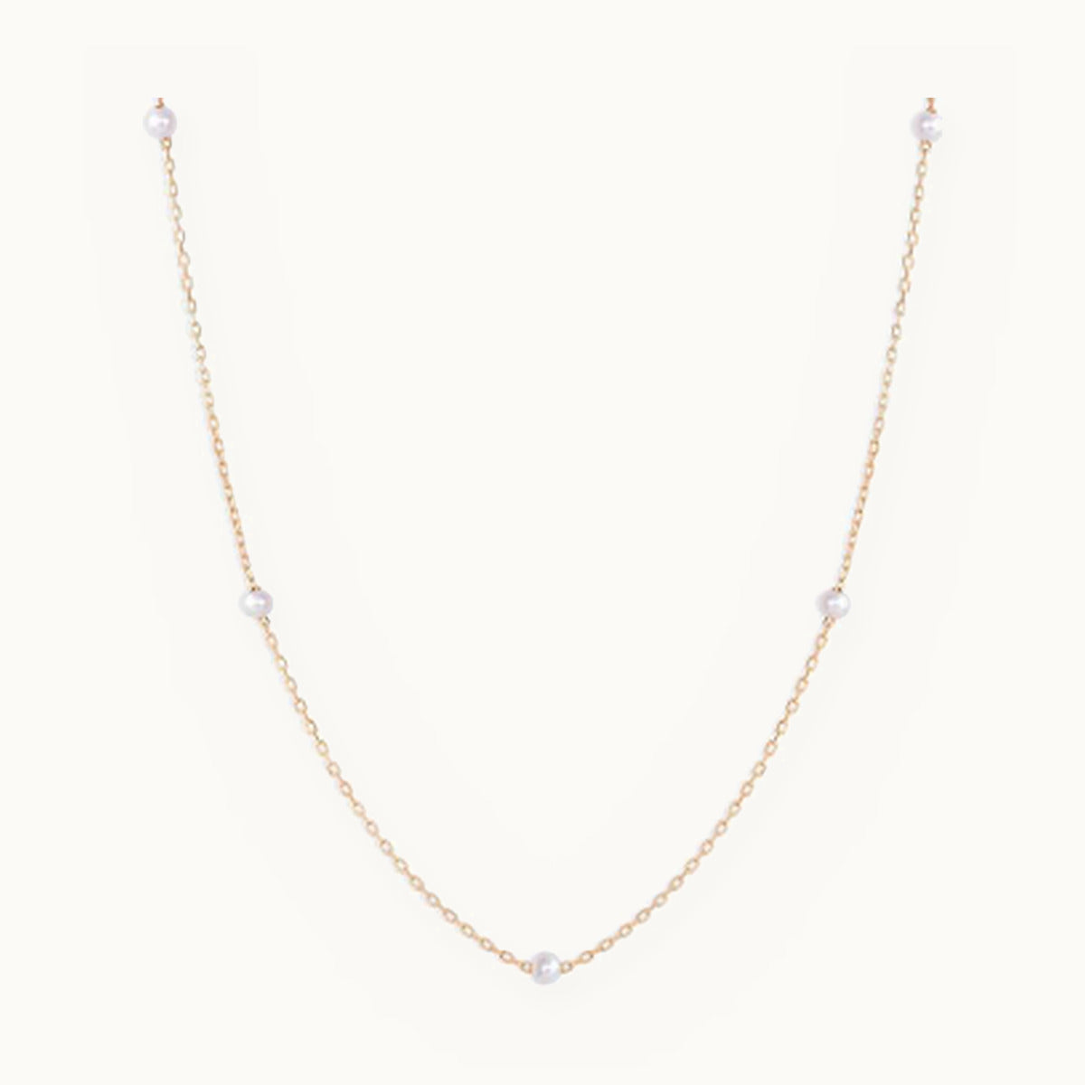 Gold chain necklace with small pearl stations