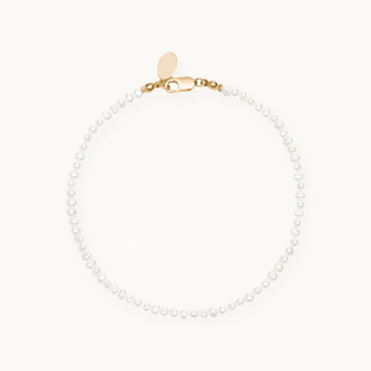 Small white pearl strand bracelet with gold clasp
