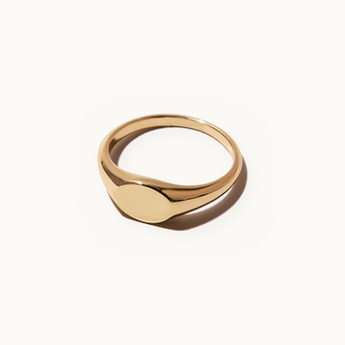 Small gold oval signet ring with a polished face