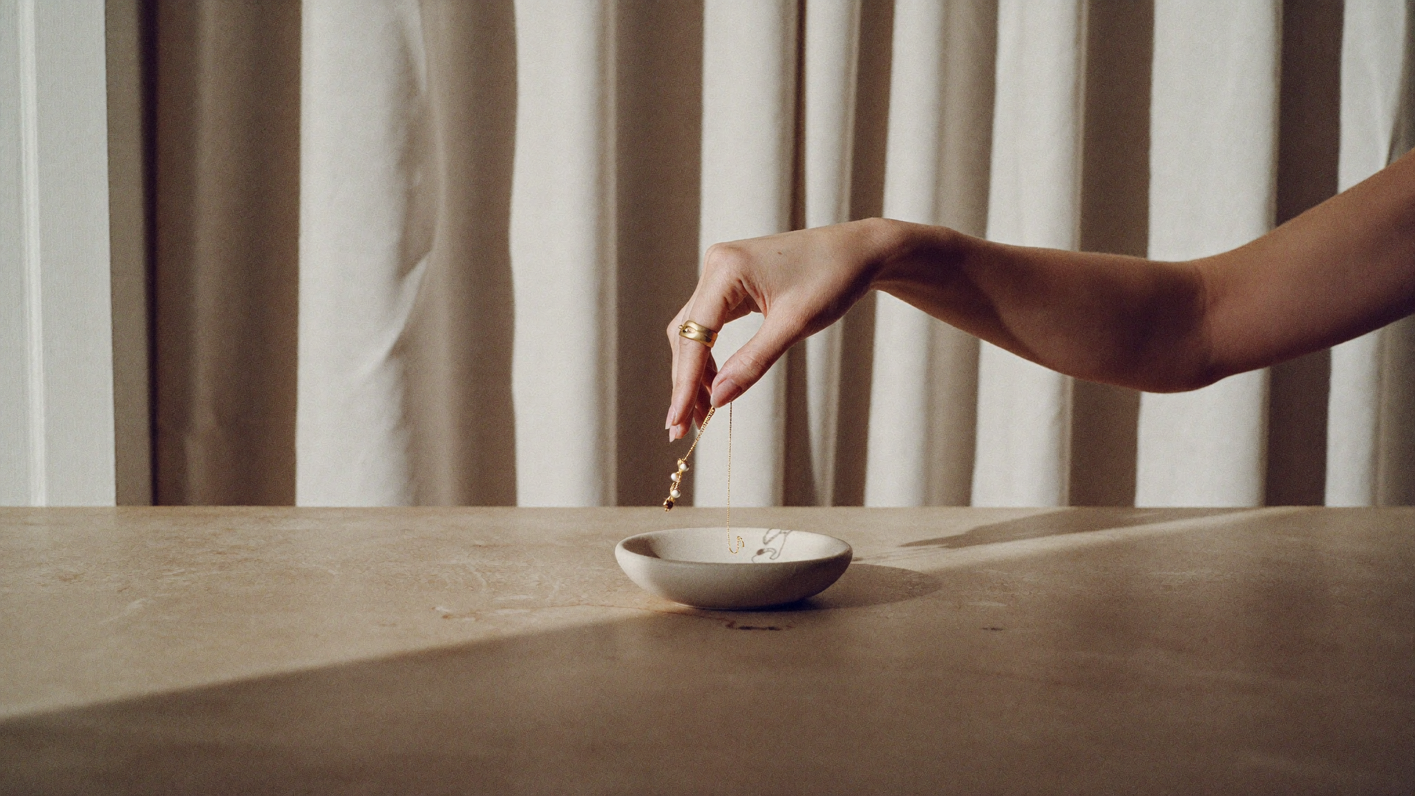 Placing SEVORR jewelry in a ceramic dish