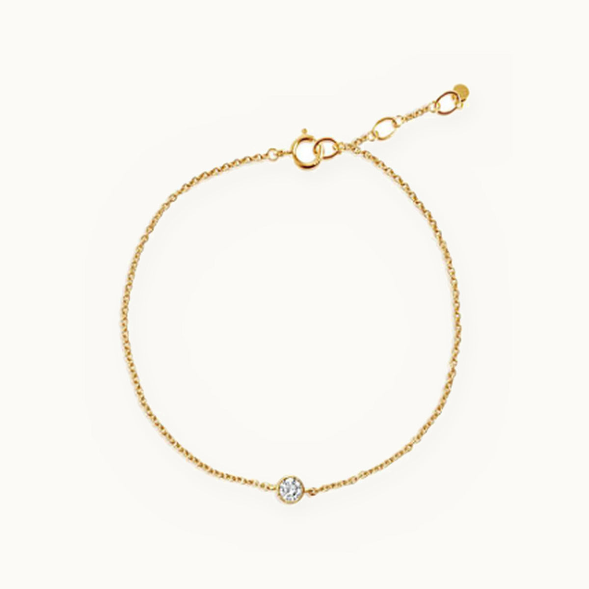 Fine gold chain bracelet with a single bezel-set stone