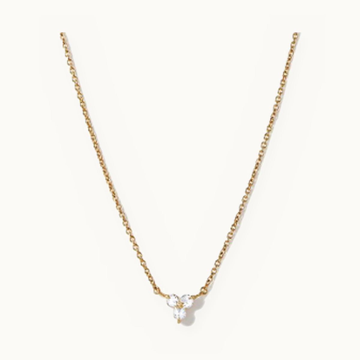 Gold necklace with a tiny three-stone cluster