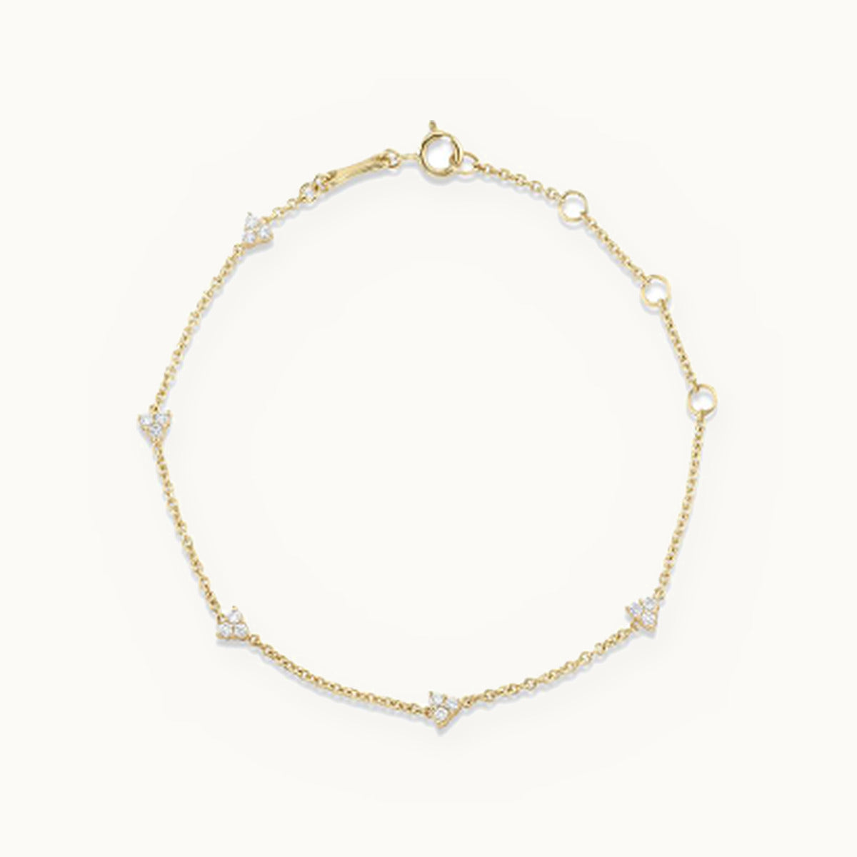 Gold chain bracelet with small three-stone clusters